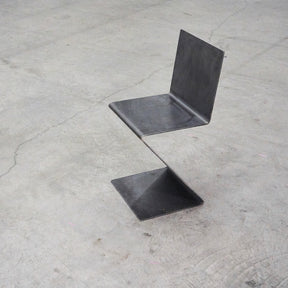 Freischwinger aus rohem Flachstahl und Rückenlehne, gefertigt aus einem Stück Flachstahl ohne Schweißnaht auf Betonboden